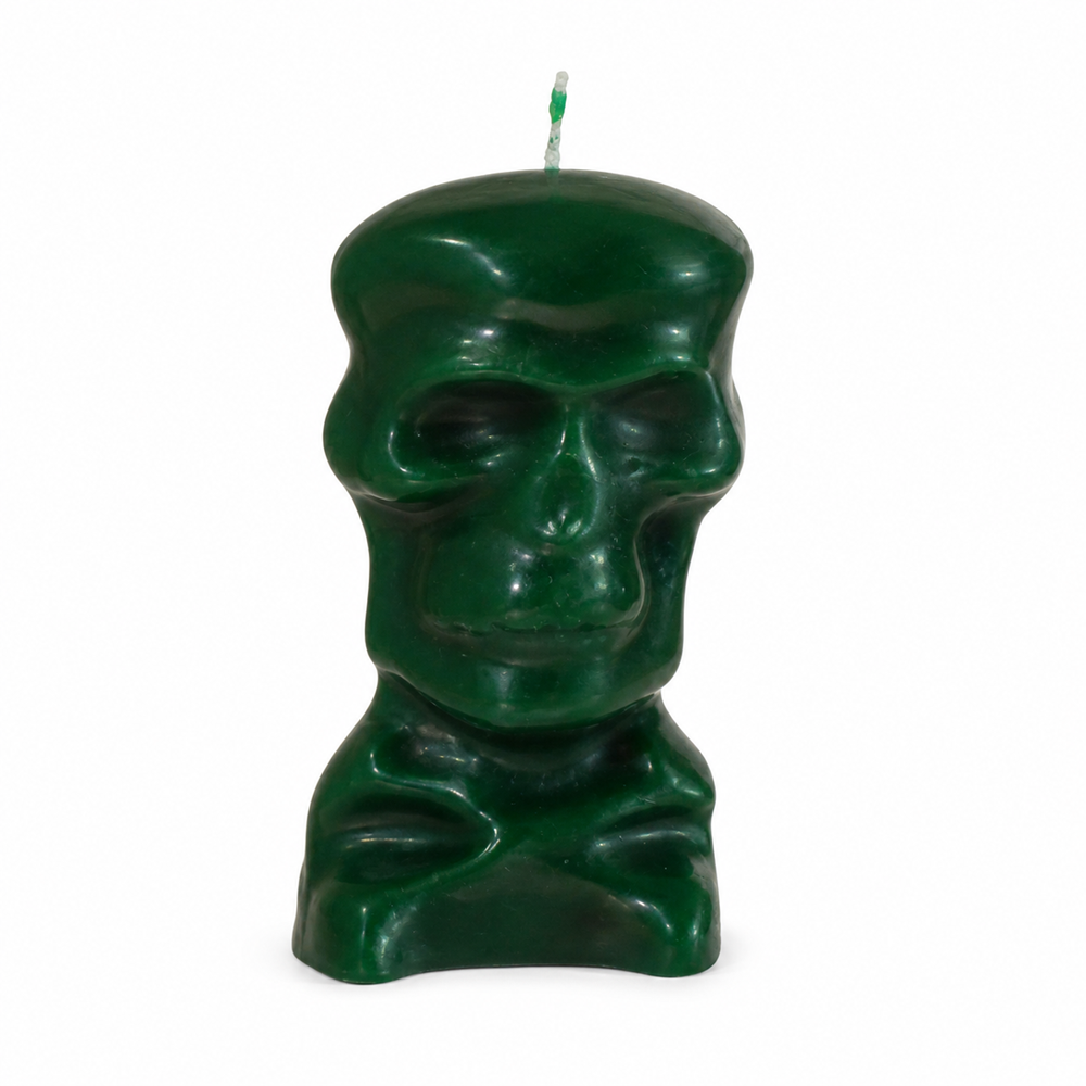 A dark green wax ritual candle sculpted into the detailed shape of a human skull and upper shoulders, featuring a single wick at the top against a white background.