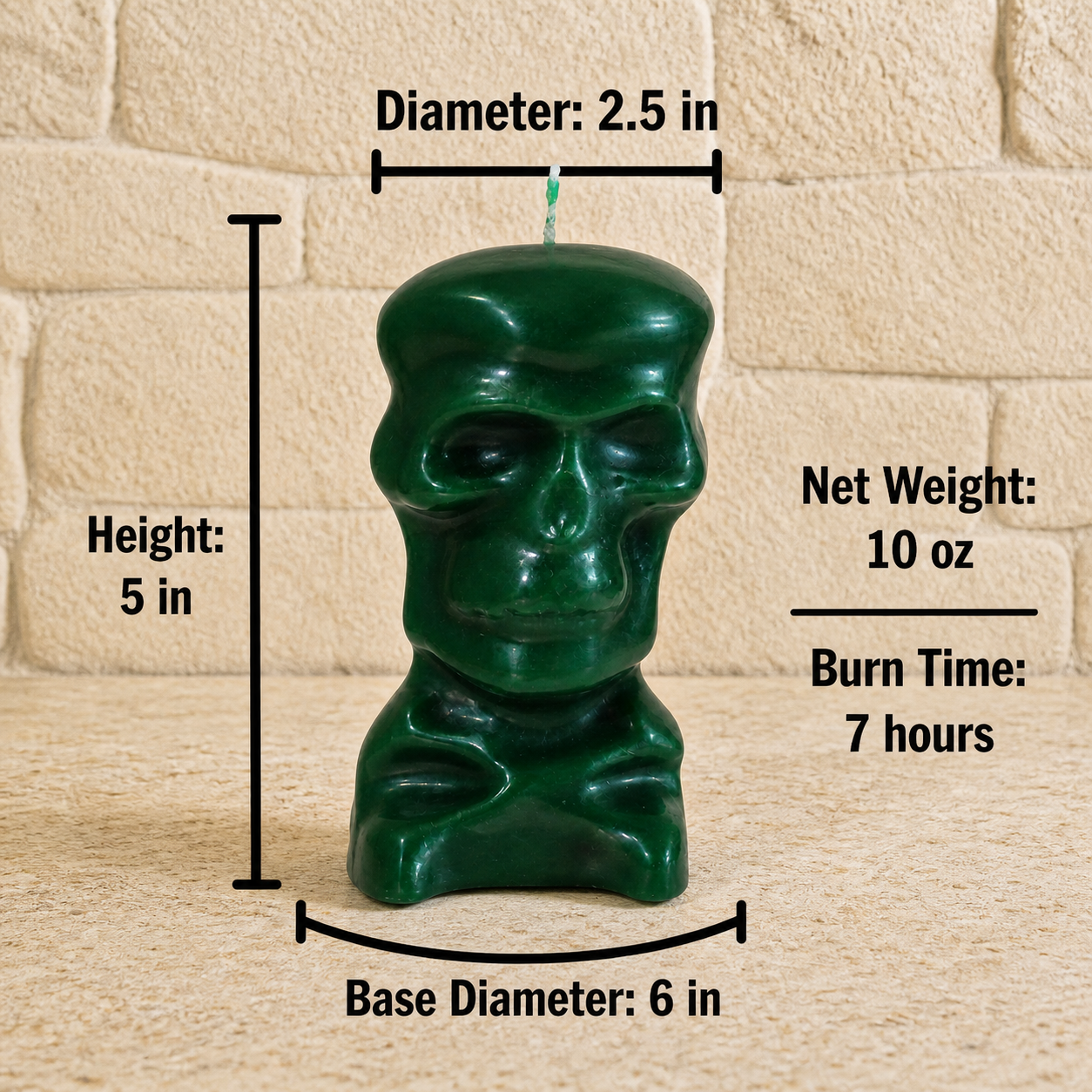 A dark green skull-shaped ritual candle is shown with technical measurements against a stone wall background. The candle is 5 inches in height, 2.5 inches in diameter at the top, and sits on a 6-inch base diameter. Text to the right indicates a net weight of 10 oz and a burn time of 7 hours. 